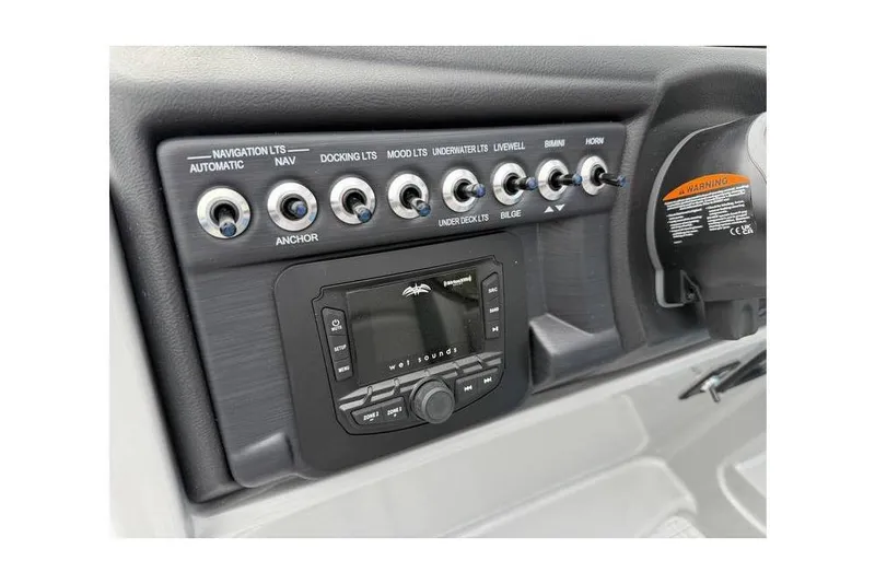 Slide: The Image of Control panel of 2026 South Bay 224 RS 3.0 Hybrid Arch boat with switches and display. - 10