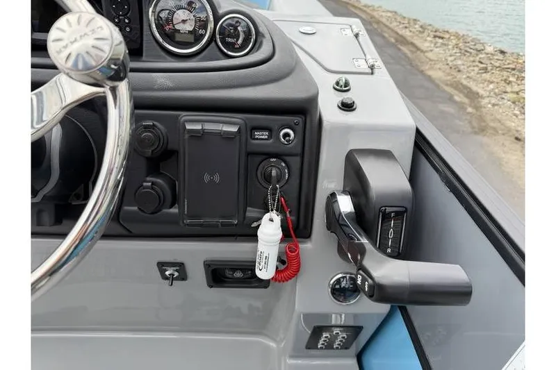 Slide: The Image of Control panel of 2026 South Bay 224 RS 3.0 Hybrid Arch boat, featuring steering wheel and gauges. - 12