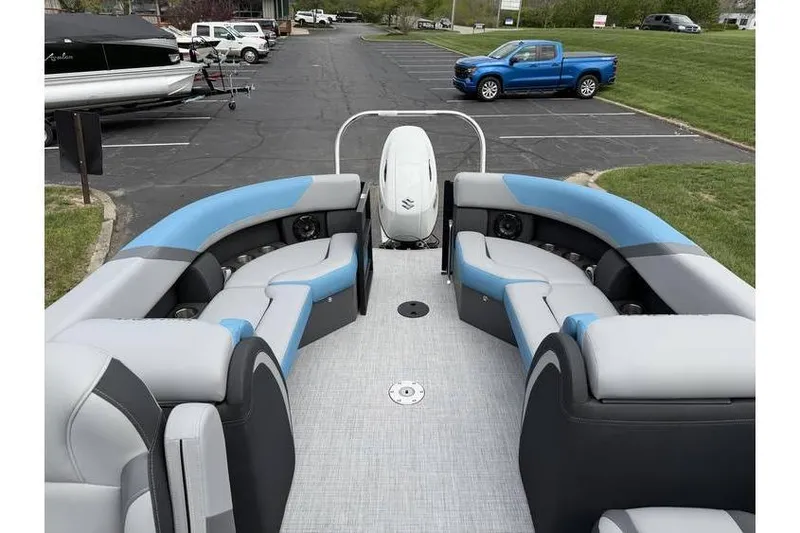 Slide: The Image of 2026 South Bay 224 RS 3.0 Hybrid Arch pontoon boat with spacious seating in a parking lot. - 18