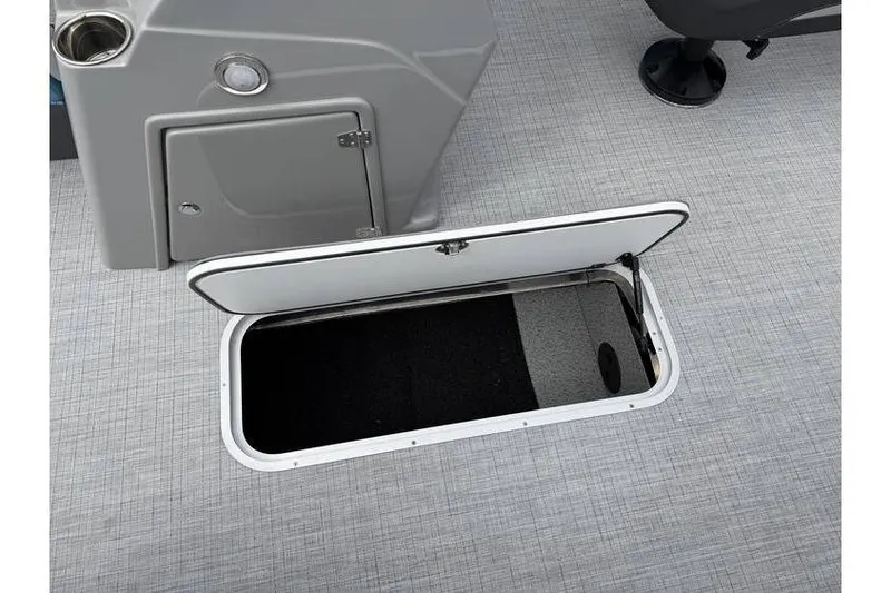 Slide: The Image of Open storage compartment on 2026 South Bay 224 RS 3.0 Hybrid Arch boat. - 19