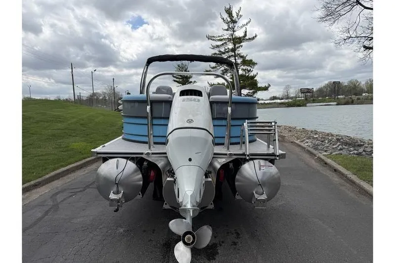 Slide: The Image of 2026 South Bay 224 RS 3.0 Hybrid Arch pontoon boat by a lakeside road. - 4
