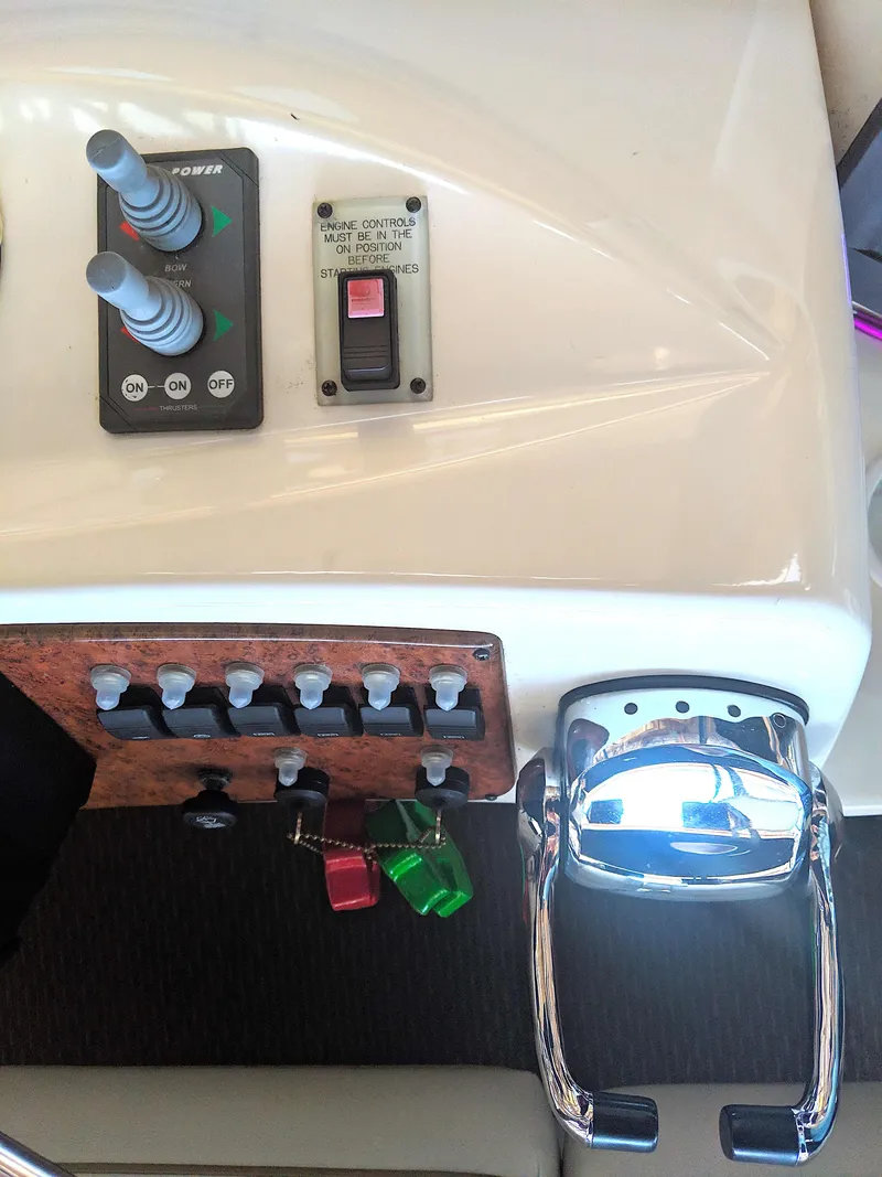 Slide: The Image of Control console of 2005 Silverton 39 Motor Yacht with switches and levers. - 13