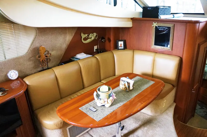 Slide: The Image of Interior of 2005 Silverton 39 Motor Yacht with leather sofa and wooden table. - 17