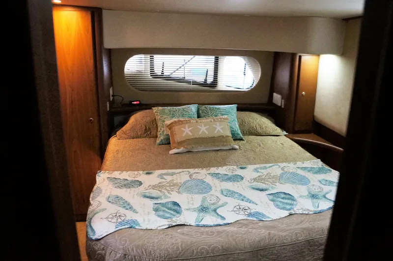 Slide: The Image of Interior of 2005 Silverton 39 Motor Yacht, cozy bedroom with nautical decor. - 23