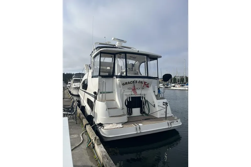 Slide: The Image of 2005 Silverton 39 Motor Yacht docked at marina, rear view with clear skies. - 3