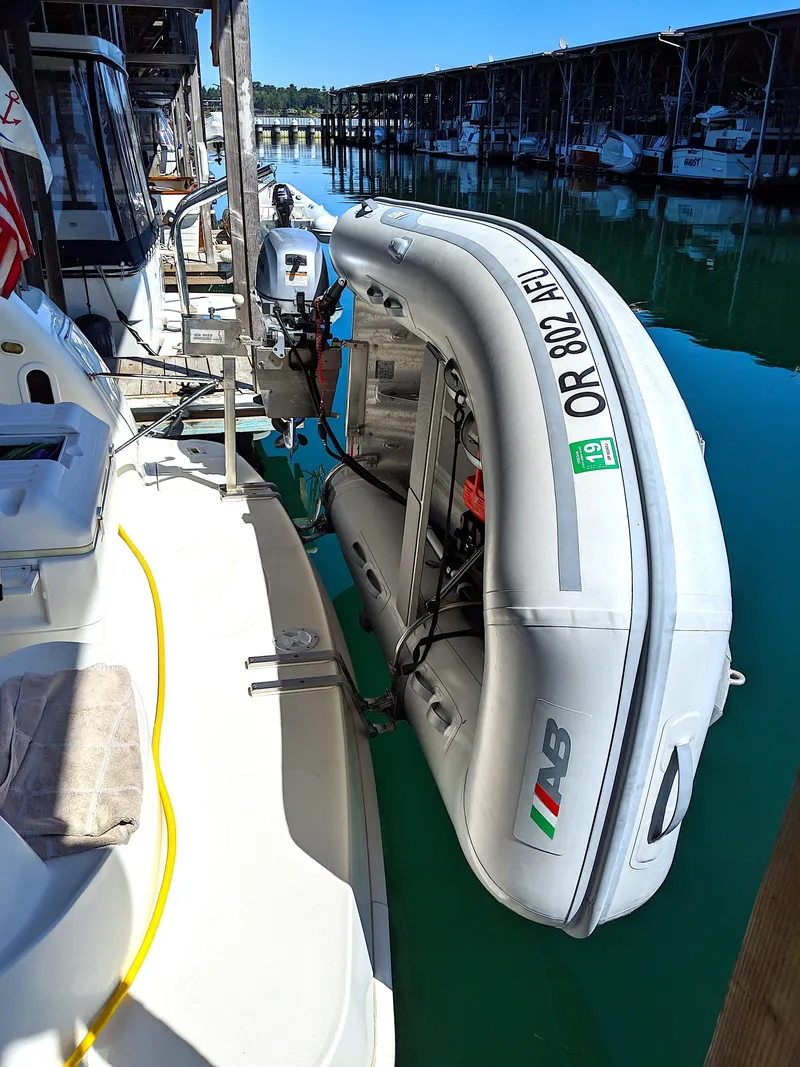 Slide: The Image of 2005 Silverton 39 Motor Yacht with dinghy in harbor. - 38
