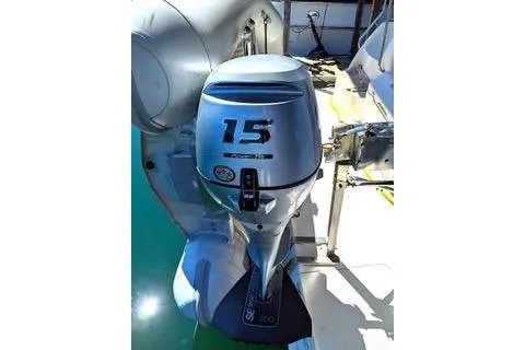 Slide: The Image of Outboard motor on a 2005 Silverton 39 Motor Yacht, docked on clear water. - 39