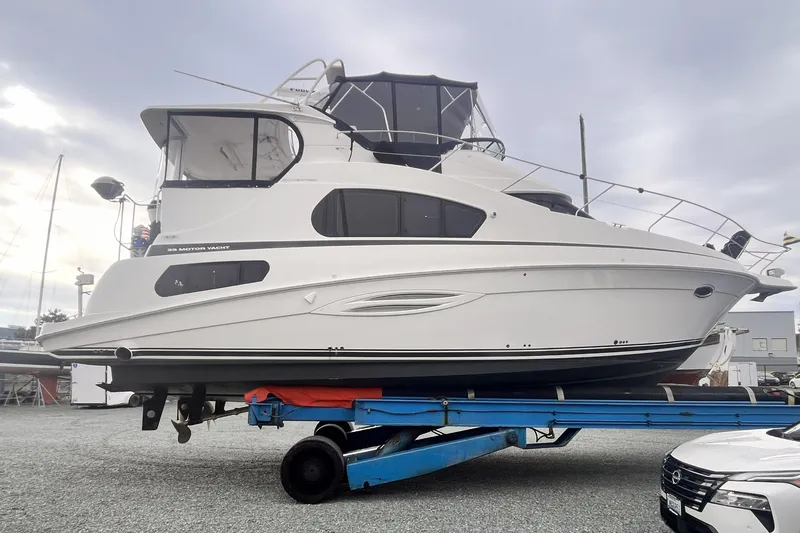 Slide: The Image of 2005 Silverton 39 Motor Yacht on trailer, displayed outdoors under cloudy sky. - 44
