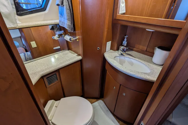 Slide: The Image of 2005 Silverton 39 Motor Yacht bathroom with wood cabinetry and modern fixtures. - 49