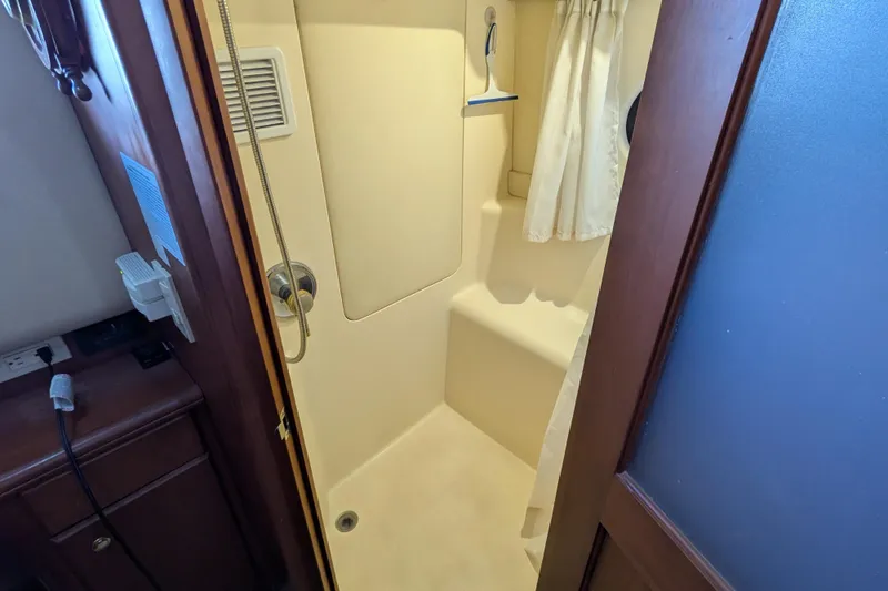 Slide: The Image of Shower area in 2005 Silverton 39 Motor Yacht with curtain and built-in seat. - 51