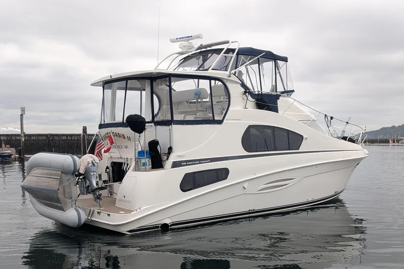Slide: The Image of 2005 Silverton 39 Motor Yacht on calm water, featuring sleek design and modern amenities. - 4