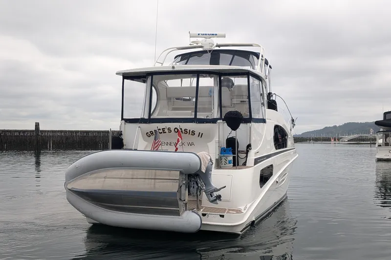 Slide: The Image of 2005 Silverton 39 Motor Yacht docked with inflatable boat attached. - 3
