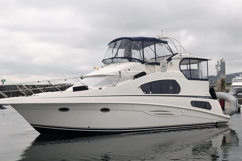 The Image of 2005 Silverton 39 Motor Yacht on calm water, featuring sleek design and spacious deck. - 0