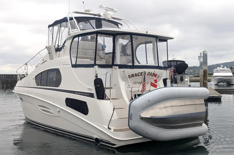 Slide: The Image of 2005 Silverton 39 Motor Yacht docked with inflatable boat attached. - 2