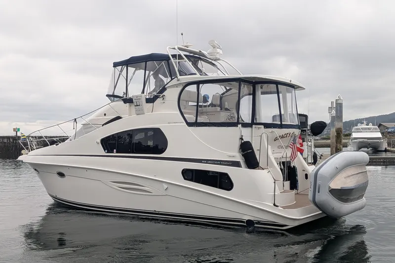 Slide: The Image of 2005 Silverton 39 Motor Yacht on calm water, featuring sleek design and modern amenities. - 1