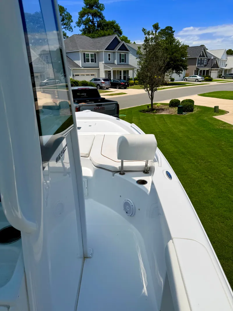 Slide: The Image of 2019 Sea Hunt BX 25 FS boat parked in residential area. - 10