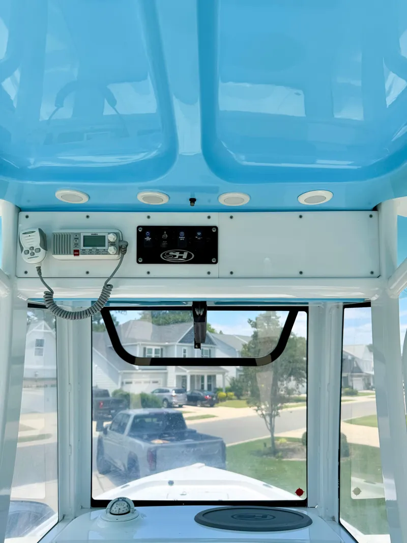 Slide: The Image of Interior view of a 2019 Sea Hunt BX 25 FS boat with blue ceiling. - 14