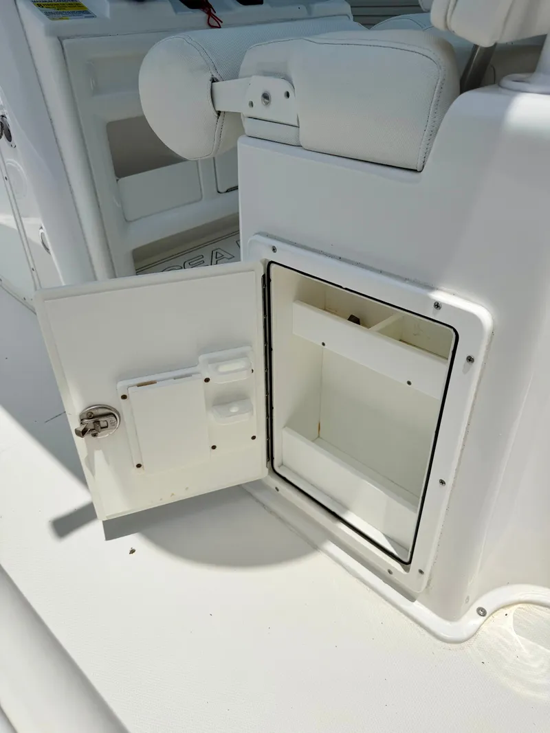 Slide: The Image of Open storage compartment on a 2019 Sea Hunt BX 25 FS boat. - 19