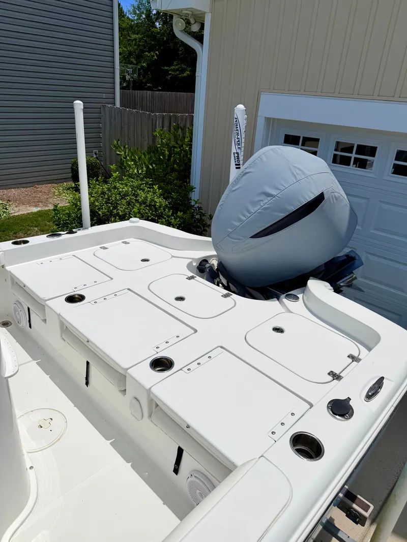 Slide: The Image of 2019 Sea Hunt BX 25 FS boat with engine cover in yard. - 23