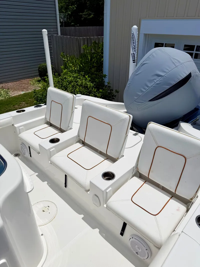 Slide: The Image of 2019 Sea Hunt BX 25 FS boat with white seats and motor cover. - 24