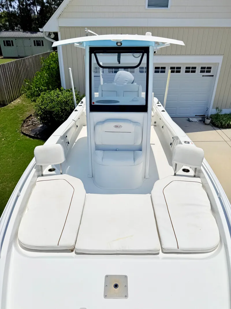 Slide: The Image of 2019 Sea Hunt BX 25 FS boat parked in a driveway. - 6