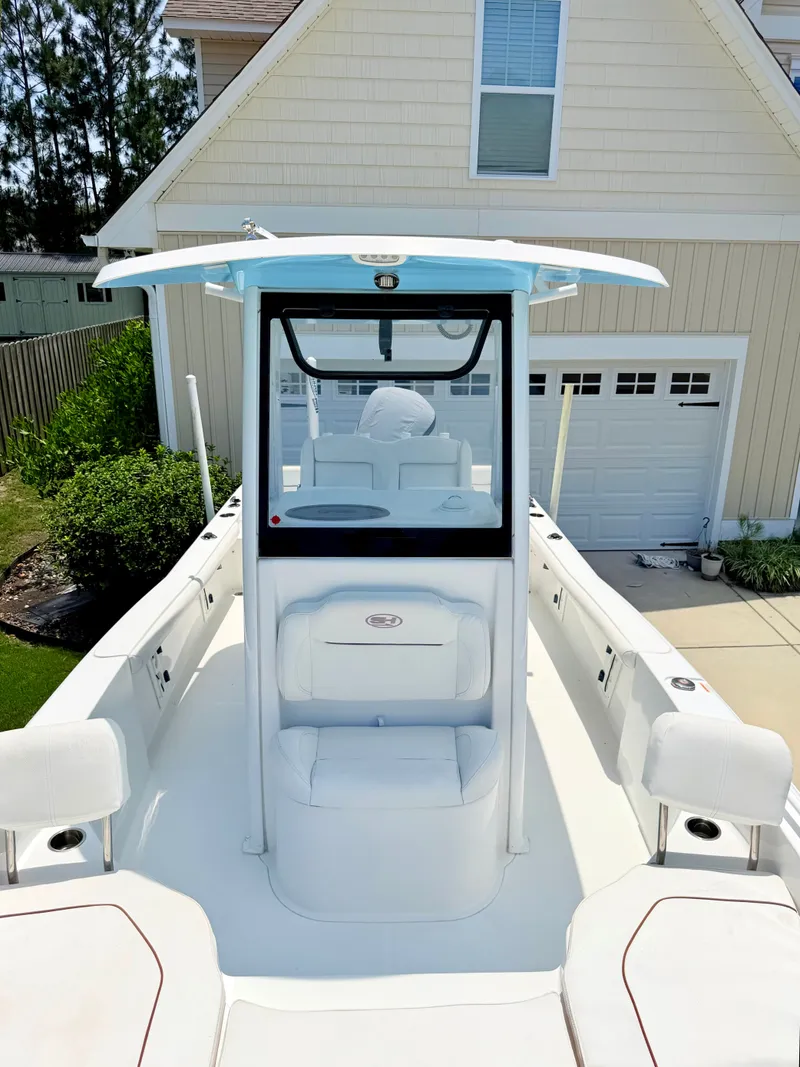 Slide: The Image of 2019 Sea Hunt BX 25 FS boat parked in front of garage. - 7