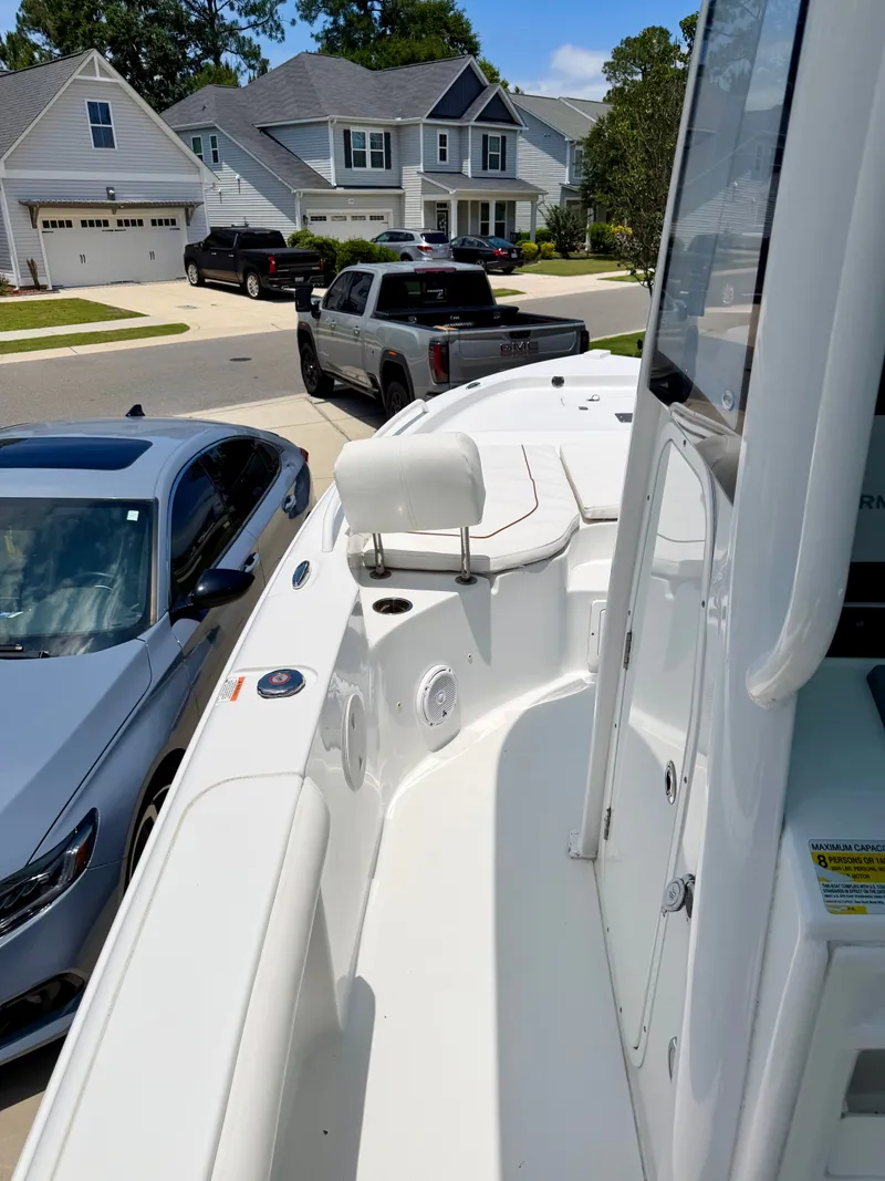 Slide: The Image of 2019 Sea Hunt BX 25 FS boat parked in residential area. - 9