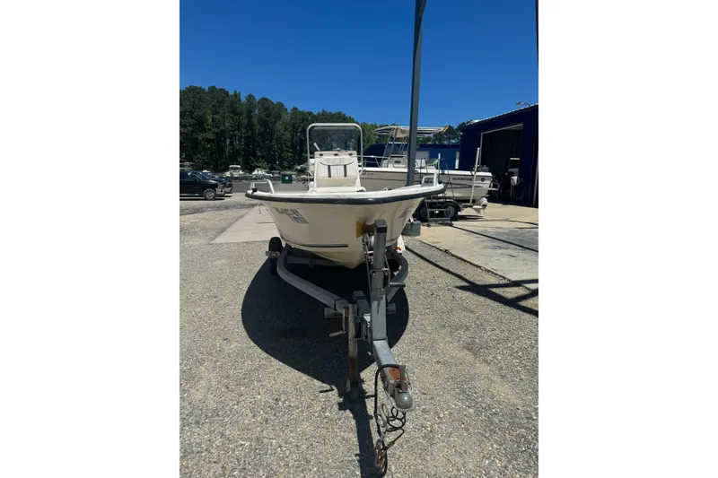 Slide: The Image of 2005 Sea Chaser 175 RG boat on trailer, parked outdoors under clear blue sky. - 10