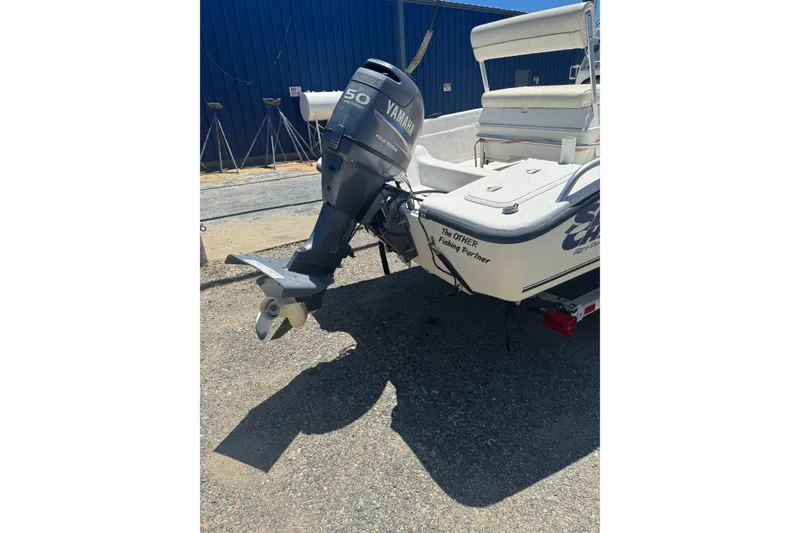 Slide: The Image of 2005 Sea Chaser 175 RG boat with Yamaha outboard motor, parked outdoors. - 9