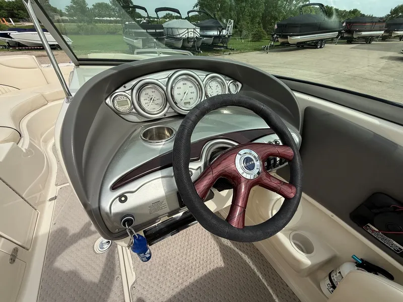 Slide: The Image of Interior view of a 2006 Azure AZ240 boat with wooden steering wheel. - 13