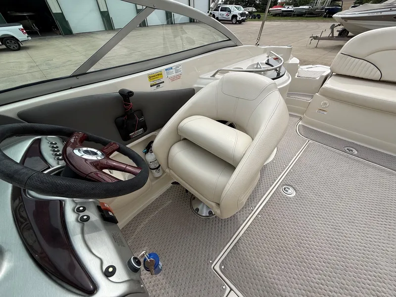Slide: The Image of Interior of a 2006 Azure AZ240 boat with steering wheel and seat. - 18