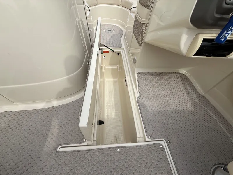 Slide: The Image of Interior of a 2006 Azure AZ240 boat with open storage compartment. - 19