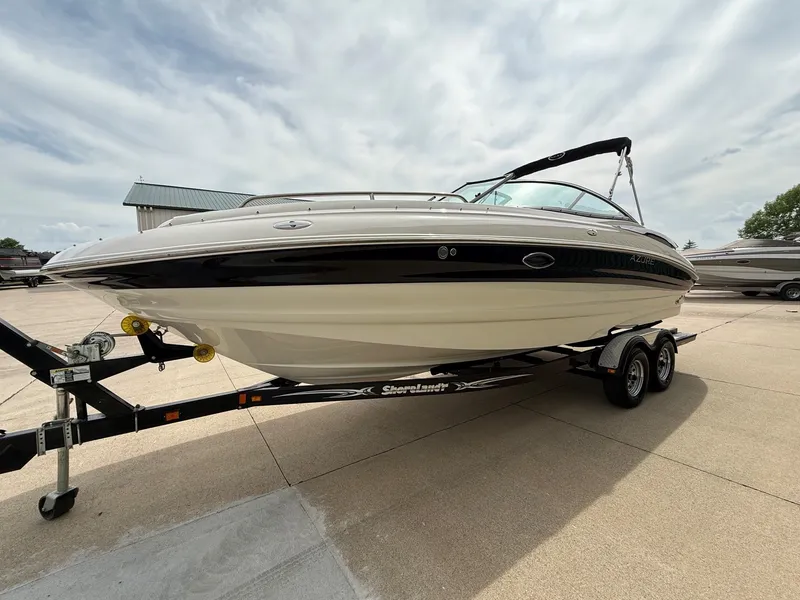 Slide: The Image of 2006 Azure AZ240 boat on trailer under cloudy sky. - 2