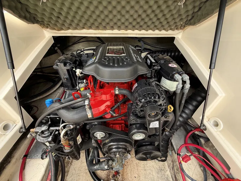 Slide: The Image of Engine compartment of a 2006 Azure AZ240 boat with red engine block. - 29