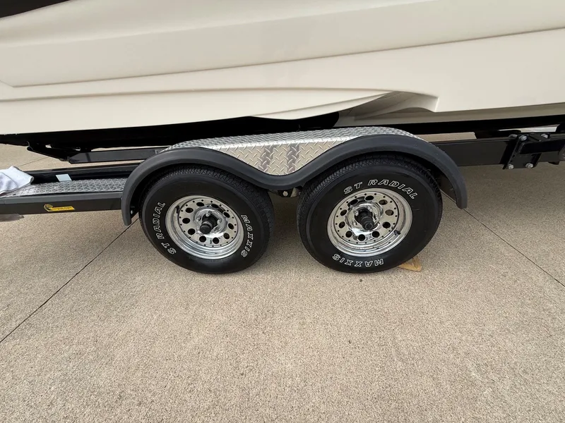 Slide: The Image of Trailer wheels of a 2006 Azure AZ240 boat. - 31