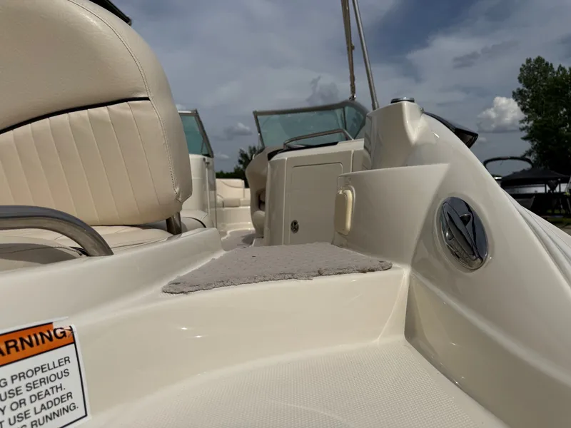 Slide: The Image of Interior view of a 2006 Azure AZ240 boat with beige seats. - 7