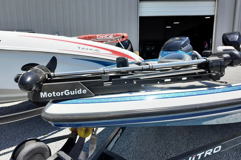 Slide: The Image of 2010 Nitro Z-7 boat with MotorGuide trolling motor, parked near Tahoe boat. - 10