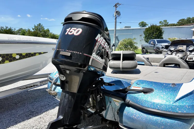 Slide: The Image of 2010 Nitro Z-7 boat with Mercury 150 outboard motor in a sunny outdoor setting. - 11