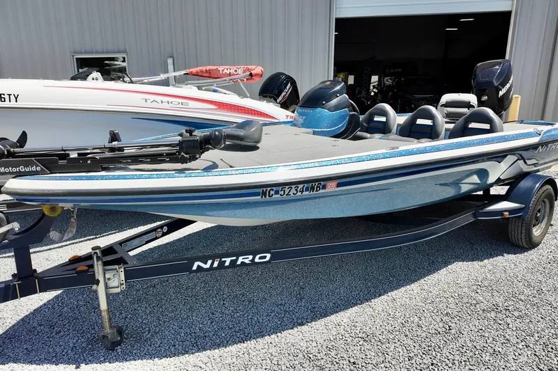 Slide: The Image of 2010 Nitro Z-7 boat on trailer, parked outside a building. - 2