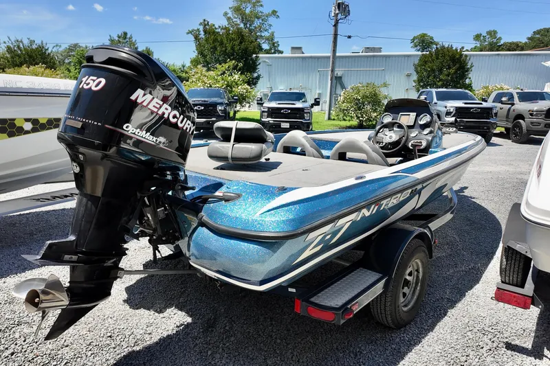 Slide: The Image of 2010 Nitro Z-7 boat with Mercury 150 engine, parked outdoors. - 3