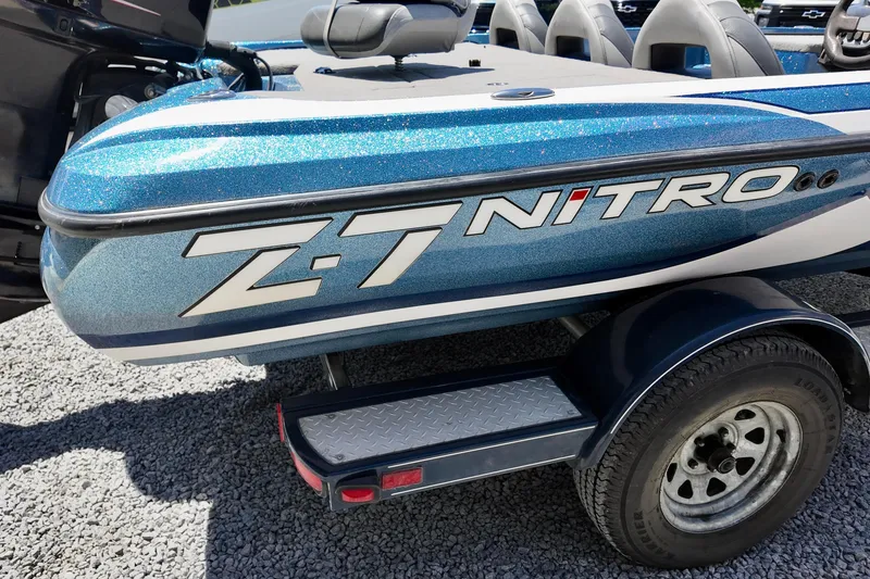 Slide: The Image of Blue 2010 Nitro Z-7 boat on trailer, featuring metallic finish and logo. - 4