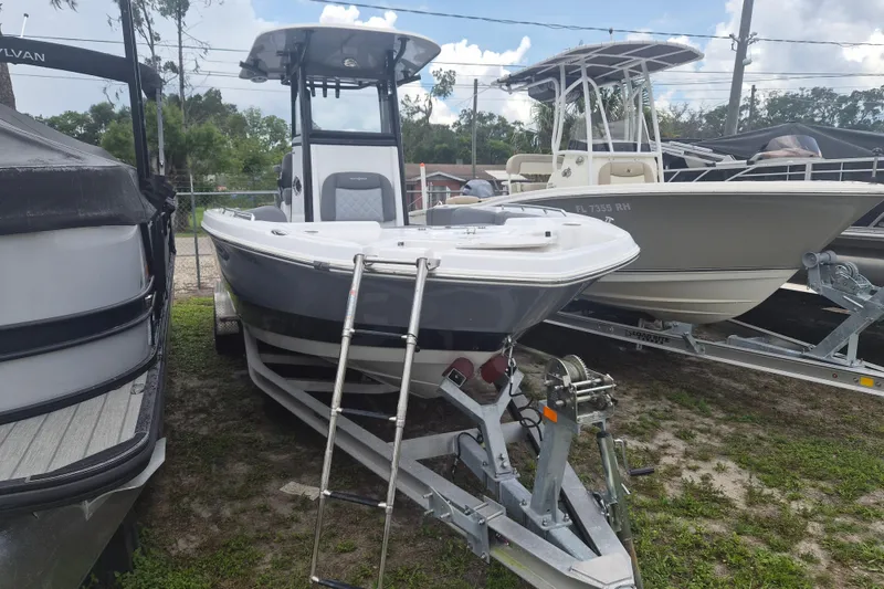 The Image of 2024 NauticStar 251 Hybrid boat on trailer, parked outdoors. - 1