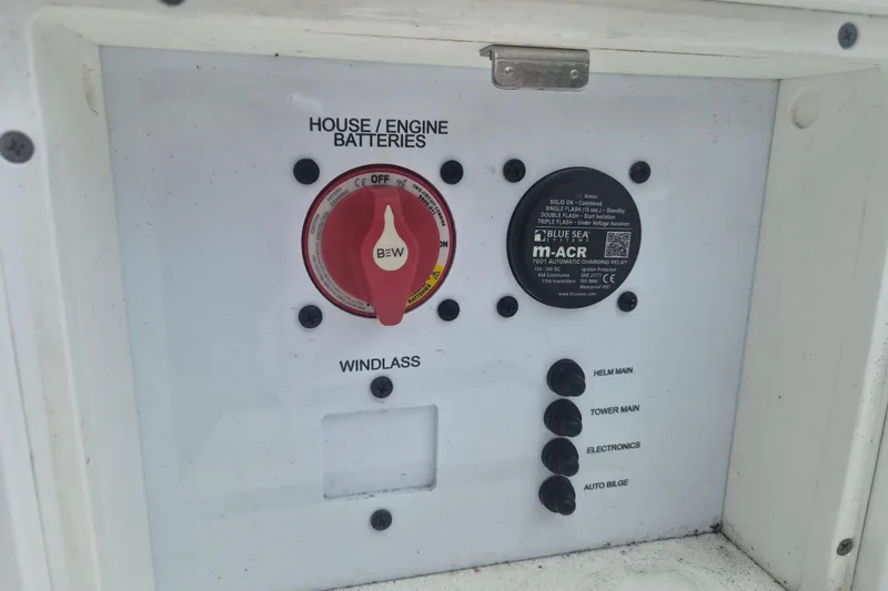 Slide: The Image of Control panel of 2024 NauticStar 251 Hybrid boat with battery switches and controls. - 11