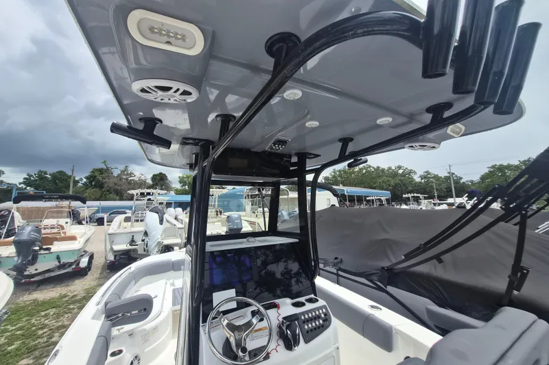 Slide: The Image of 2024 NauticStar 251 Hybrid boat interior with advanced dashboard and canopy features. - 17