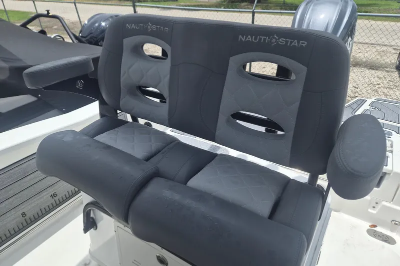 Slide: The Image of 2024 NauticStar 251 Hybrid boat seats with armrests and quilted design. - 19