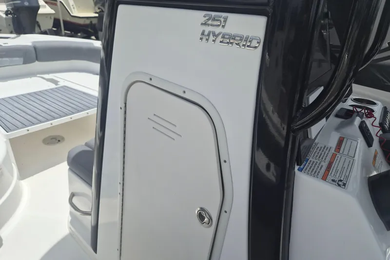 Slide: The Image of 2024 NauticStar 251 Hybrid boat interior with sleek design and storage compartment. - 25