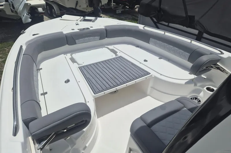 Slide: The Image of 2024 NauticStar 251 Hybrid boat interior with cushioned seating and table. - 27