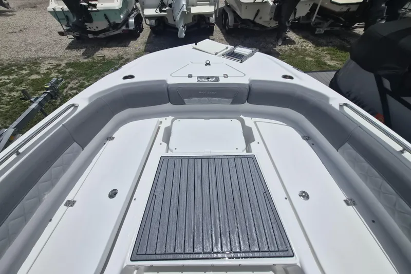 Slide: The Image of 2024 NauticStar 251 Hybrid boat interior with cushioned seating and deck. - 28