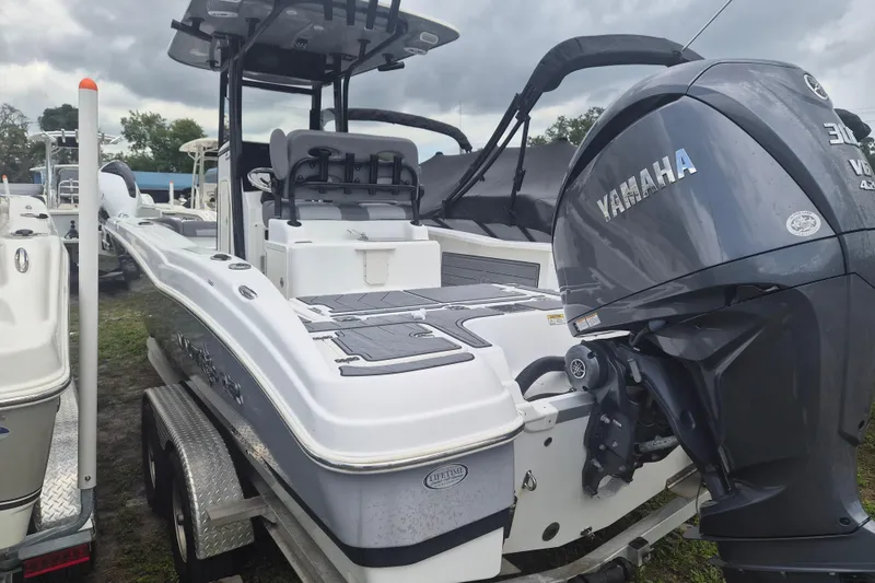 Slide: The Image of 2024 NauticStar 251 Hybrid boat with Yamaha engine on trailer. - 3