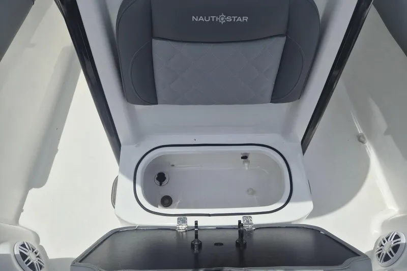 Slide: The Image of 2024 NauticStar 251 Hybrid boat seat with storage compartment open. - 35